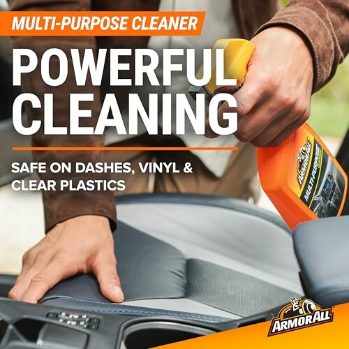 Person using ArmorAll multi-purpose cleaner on car interior.