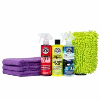 Car cleaning products with purple towels and green mitt.