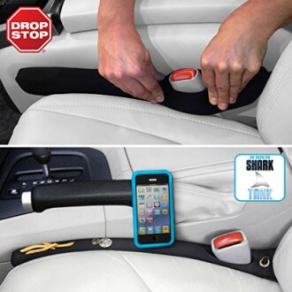 Car seat gap filler with phone and items shown in use.